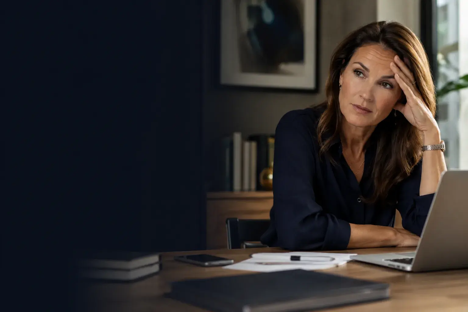 A composed, reflective woman in a beautifully lit room: calm, accomplished, self-possessed